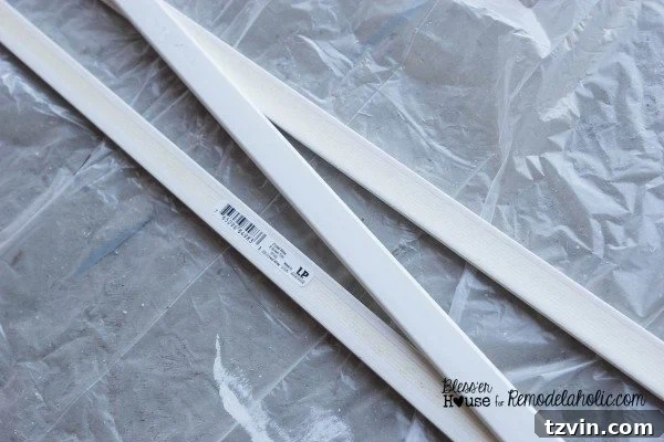 Cutting polystyrene lattice moulding pieces to create the vertical sections of the industrial factory window grid.
