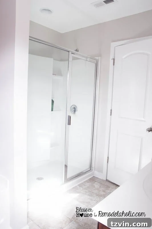 Cleaning the shower door meticulously to remove soap scum before painting, ensuring proper paint adhesion for the DIY industrial look.