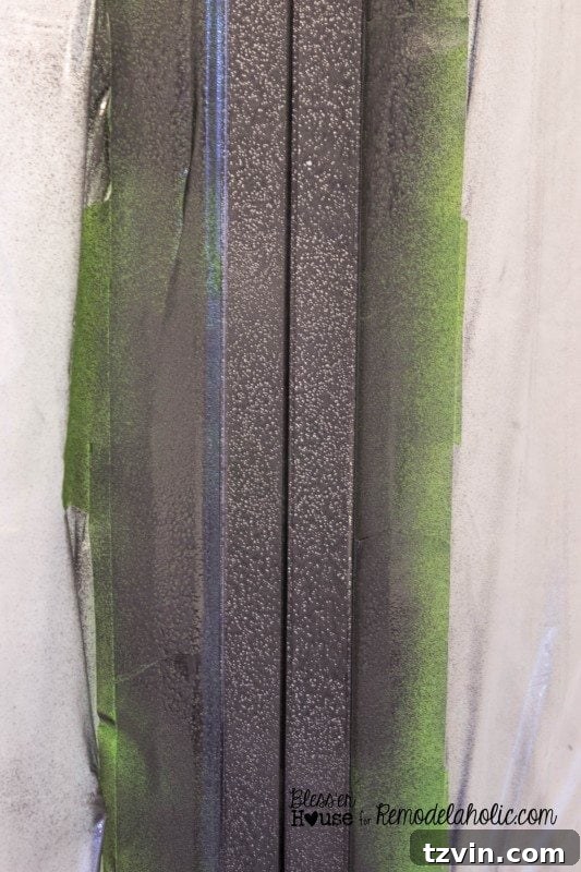 Progress shot after the second coat of hammered black spray paint, showing the industrial transformation taking shape.
