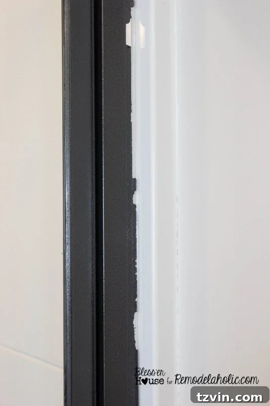 Example of paint lifting after improper tape removal, highlighting the importance of scoring painter's tape with a putty knife.