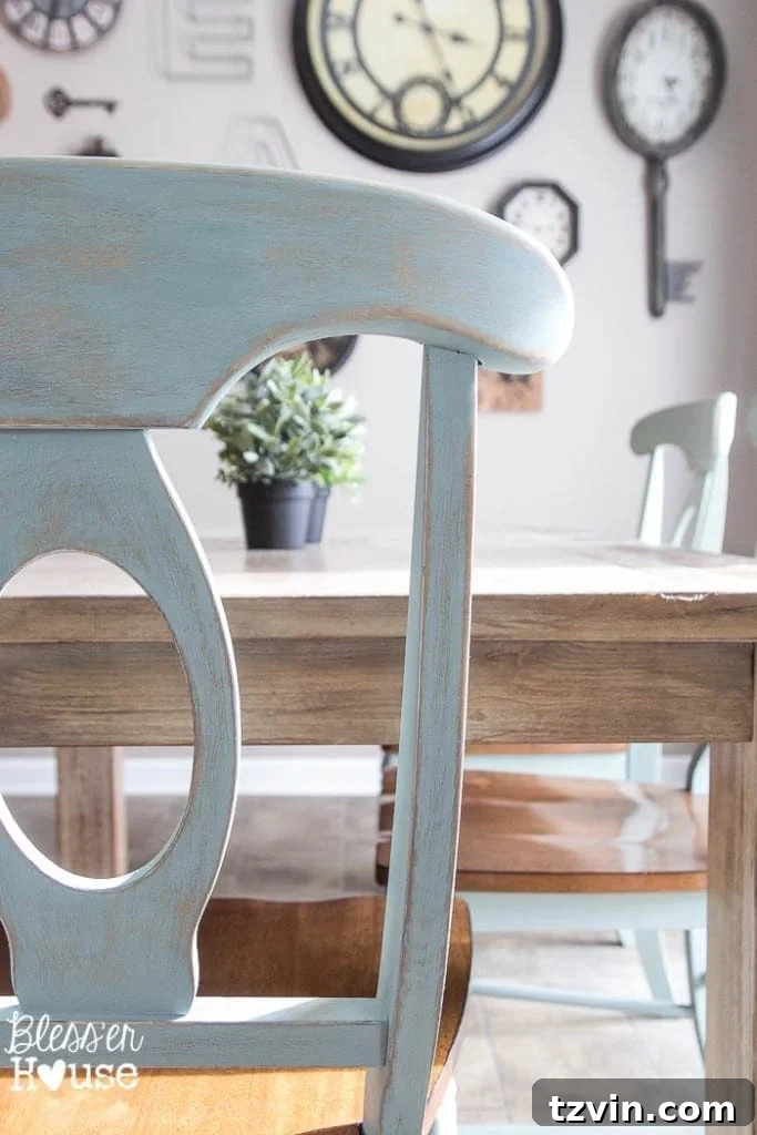 Beautifully distressed dining chairs painted in a serene duck egg blue, showcasing the transformative power of chalk paint for a farmhouse or cottage-style kitchen.