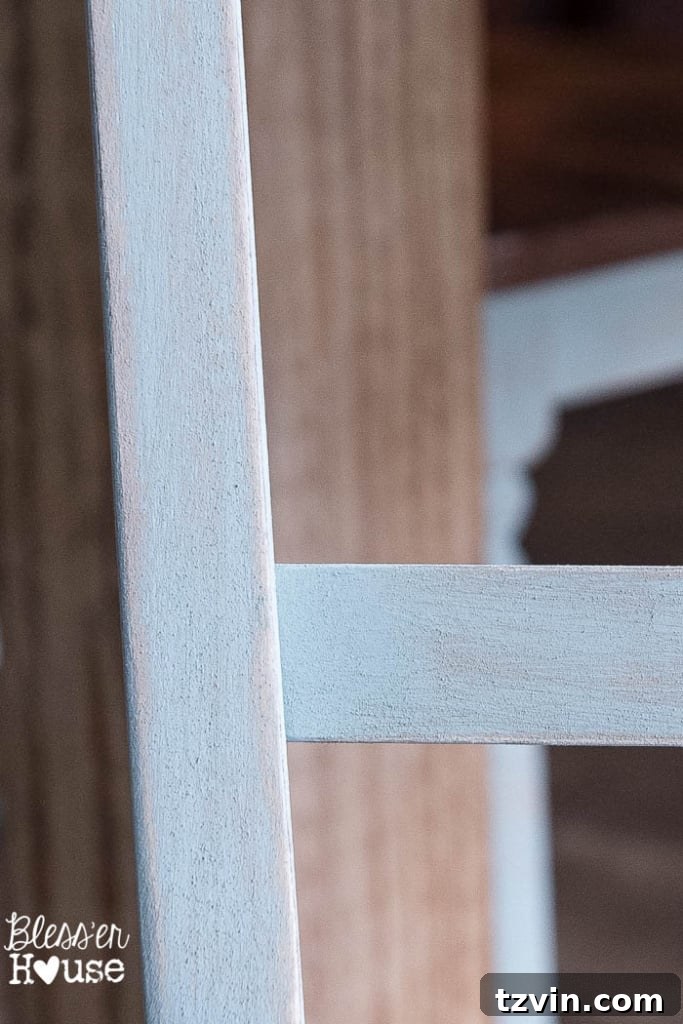Detailed shot of a beautifully distressed duck egg blue dining chair, highlighting the textured and aged appearance.