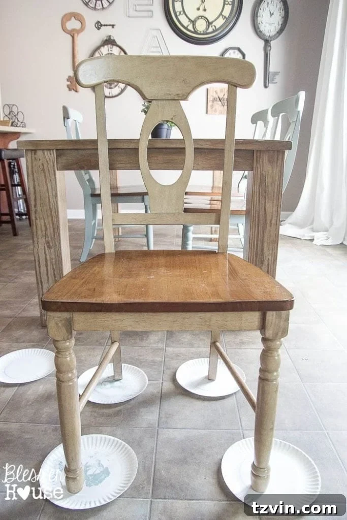 Before shot of the original 'weathered' wood dining chairs, highlighting their previous manufactured look before the chalk paint transformation.