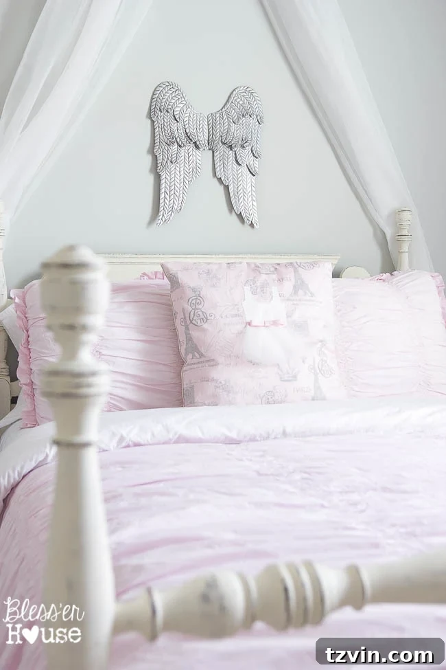 Our Prima Ballerina's Dream Bedroom Transformation 9 Aged metal angel wings on wall beside ballerina girl's bed