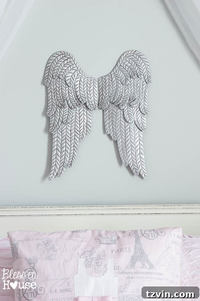 Our Prima Ballerina's Dream Bedroom Transformation 10 Close up of aged metal angel wings and handcrafted applique pillow