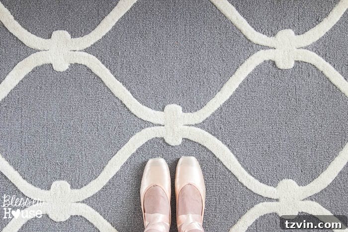12 Greige Rugs That Look Expensive But Aren't 6 A child enjoying a soft greige Safavieh rug from Overstock: Highlighting the comfort and plushness of a budget-friendly area rug, perfect for children's rooms or any space needing a soft, inviting touch.