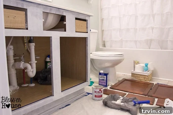 Applying primer to a cabinet door with a high-density foam roller to achieve a smooth and even finish