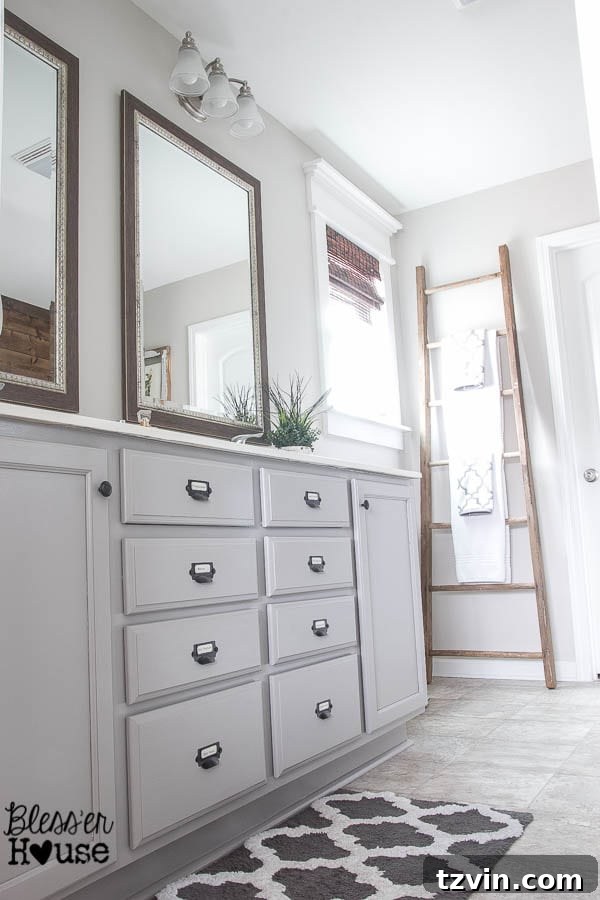 Stylishly updated bathroom with freshly painted cabinets, showcasing a modern, rustic industrial aesthetic