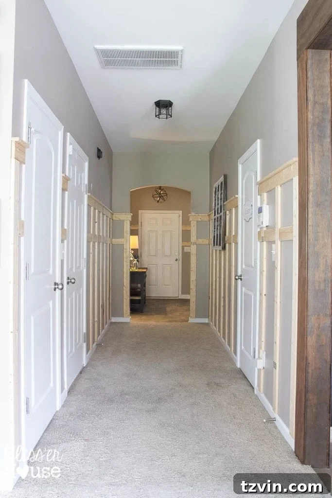 Adding board and batten wainscoting to a dark hallway with a shelf detail