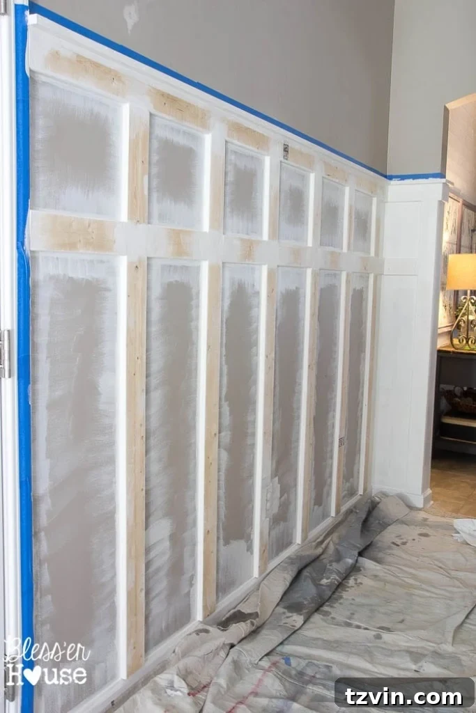 Using a mini roller to paint board and batten walls.