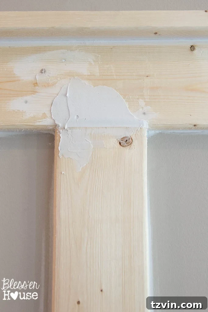 Detailed view of spackled and caulked board and batten, before sanding.