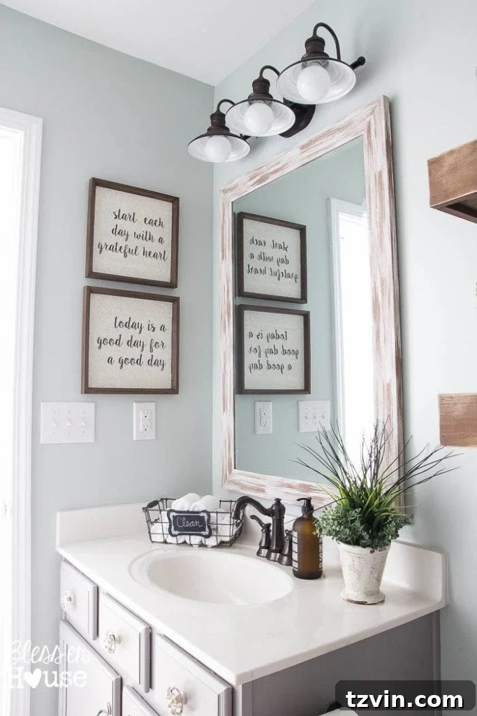 Stunning distressed white driftwood mirror, a budget-friendly focal point in the modern farmhouse bathroom vanity area.