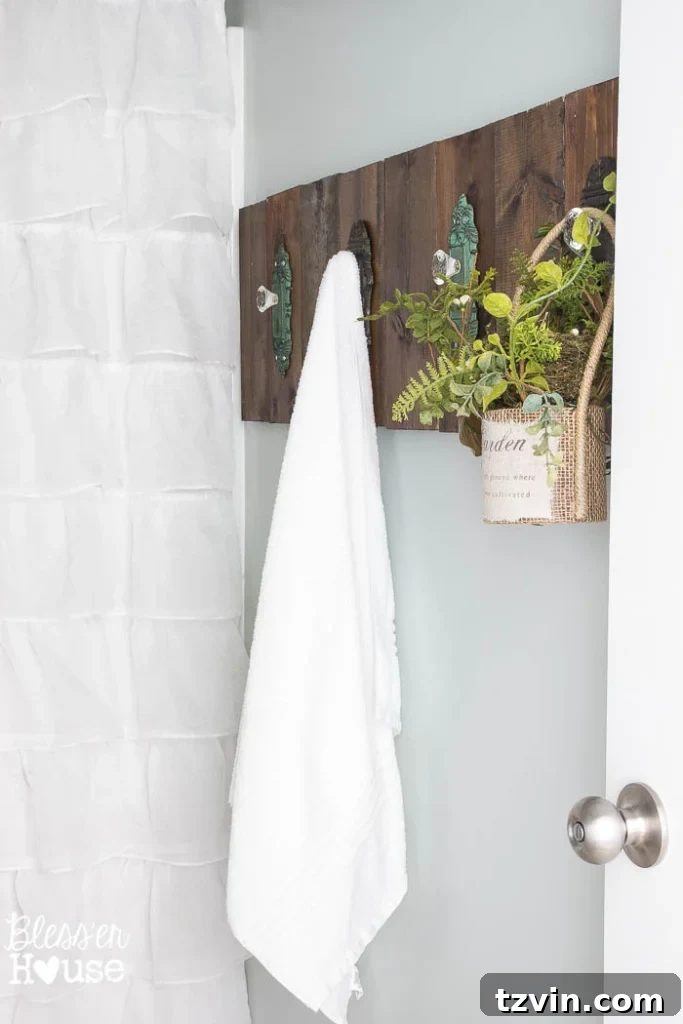 Close-up of the ruffled white shower curtain, repurposed from a photography backdrop, adding soft texture to the modern farmhouse bathroom.