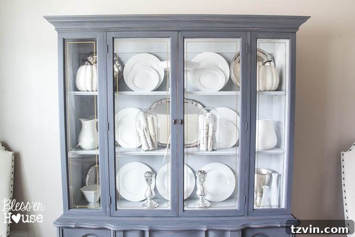 French Provincial Hutch Reimagined 9 French Provincial China Cabinet Makeover: Interior painted in Sterling, showcasing displayed silver and china