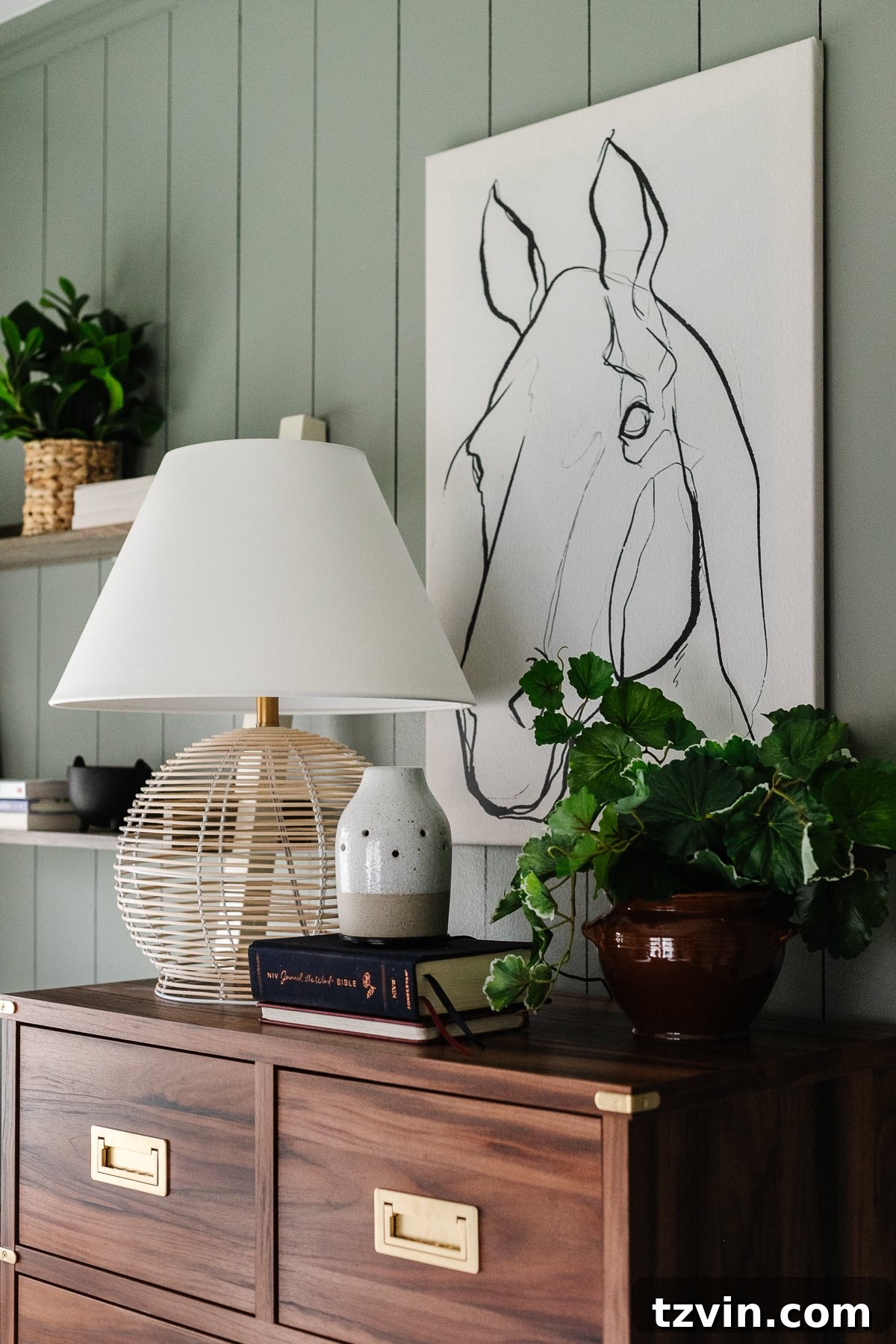 Find Your Perfect Furniture and Cabinet Hardware 17 wooden dresser in bedroom with horse drawing, rattan lamp, and plant on top