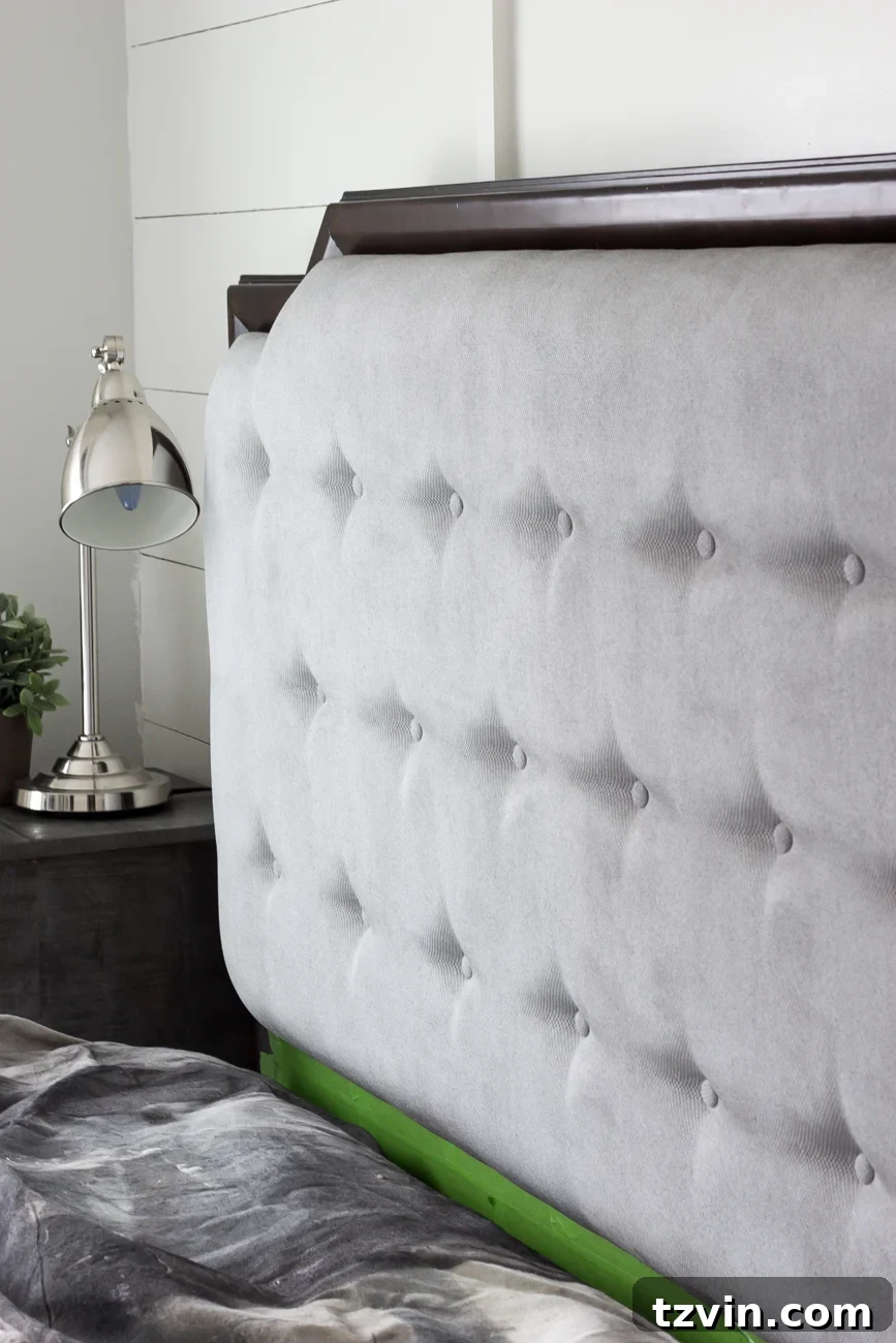 Revitalize Your Sofa: Easy Upholstery Painting 8 Applying final coat of paint to fabric headboard