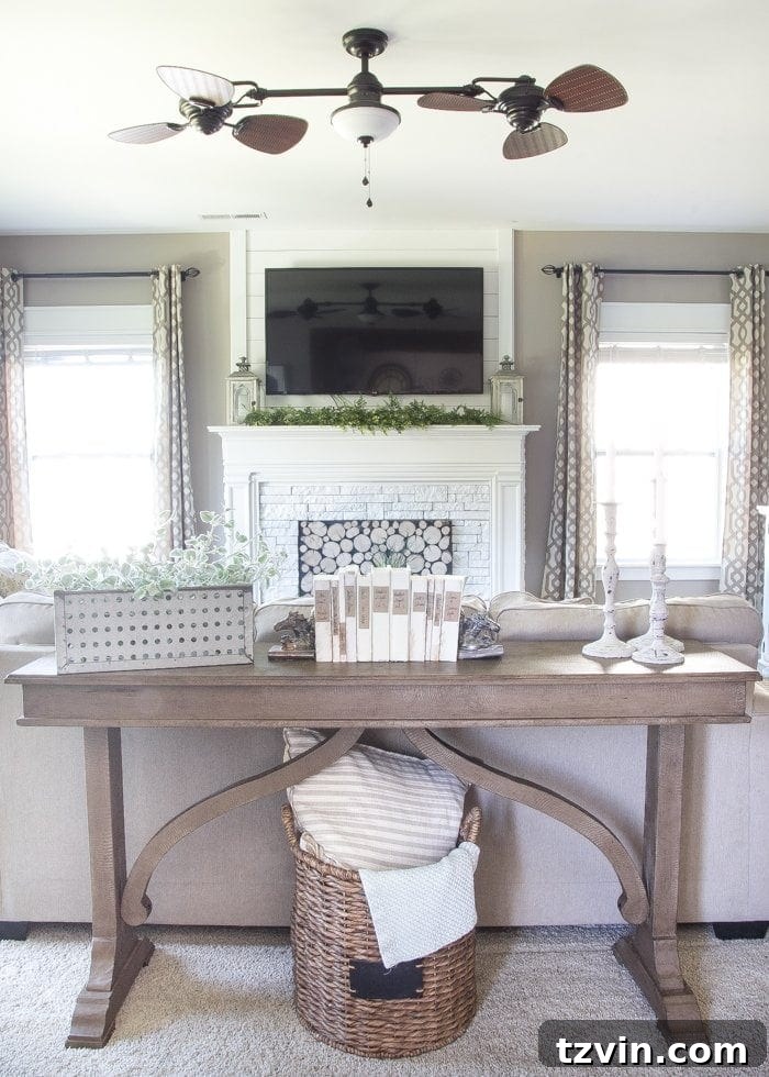 Living room view showing the weathered wood table creating separation