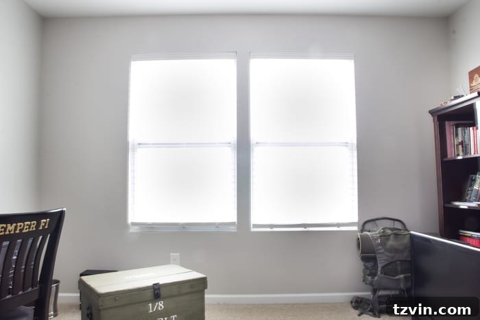 Before shot of the office windows with plain blinds, showcasing the need for a DIY Roman shades makeover