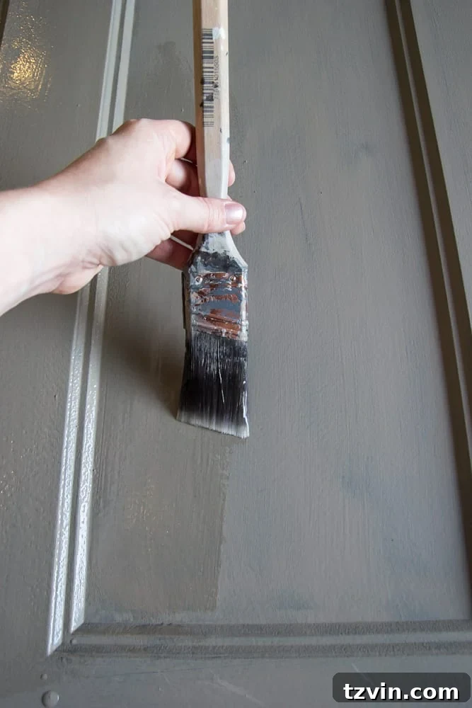 Vintage Makeover: Distressing Hollow Core Doors 5 Applying crackle medium to hollow core door for chippy paint