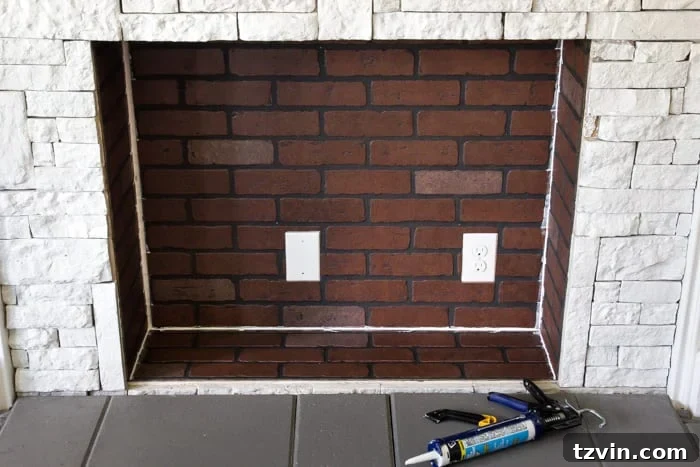 Seamless Integration: Outlets Hidden with Flat Black Paint in Faux Firebox