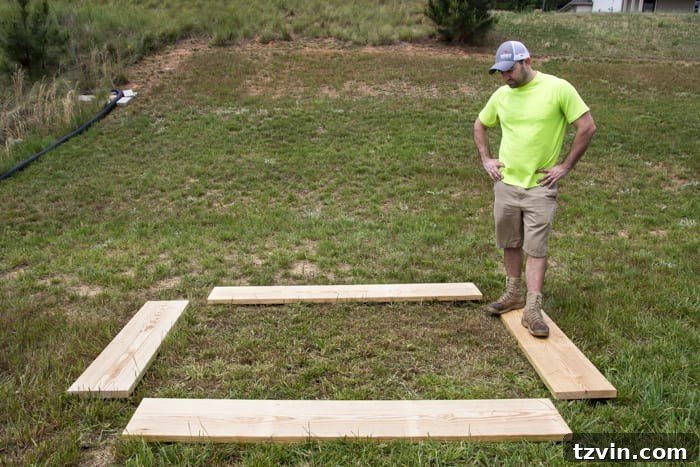 Raised Bed Revolution: Achieving Abundant Vegetable Harvests 8 pine boards in a backyard laid out for building a raised bed vegetable garden frame