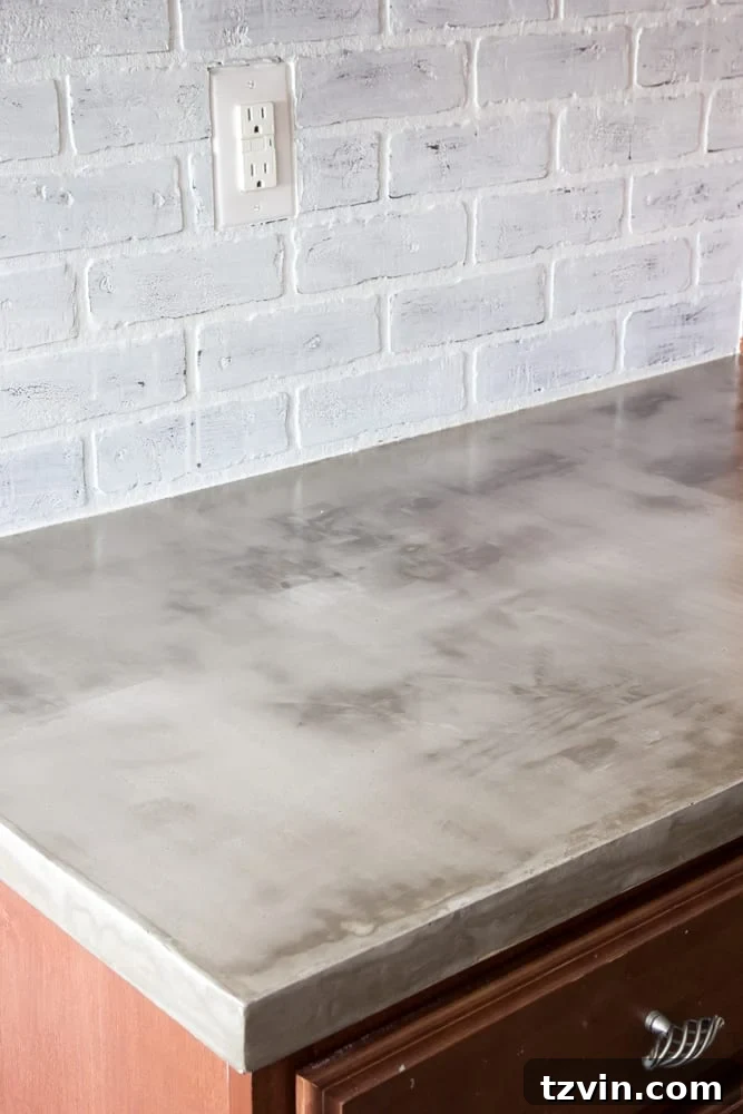 Kitchen with new concrete countertops and whitewashed brick backsplash