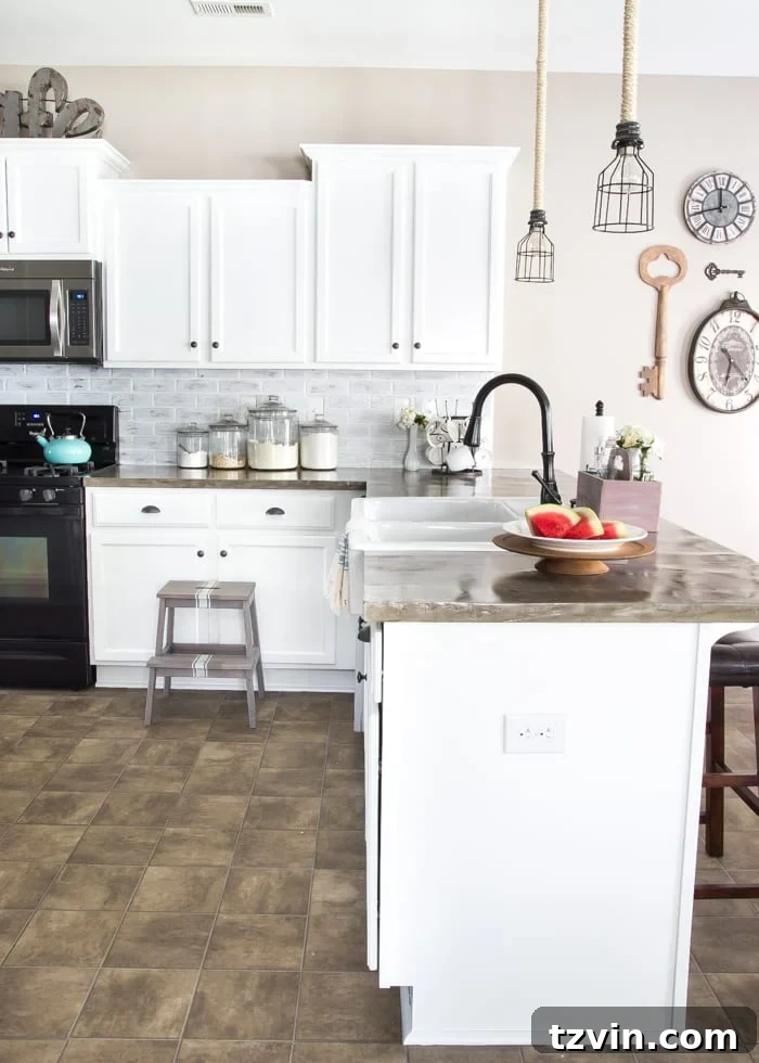 Elevate Your Kitchen: Pro Strategies for Cabinet Painting 13 A bright, newly painted white kitchen with the cabinet doors reinstalled and new hardware, showcasing the dramatic transformation after painting kitchen cabinets.