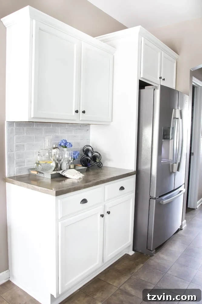 Elevate Your Kitchen: Pro Strategies for Cabinet Painting 14 A wider view of the newly painted white kitchen cabinets, showing the light and airy feel they bring to the space, part of a comprehensive kitchen makeover.