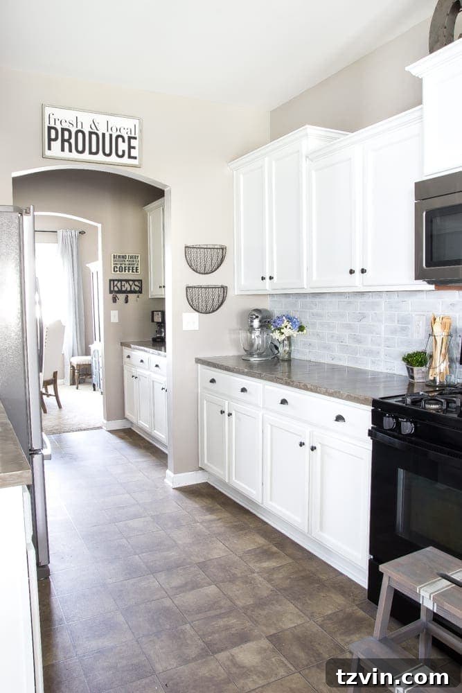Elevate Your Kitchen: Pro Strategies for Cabinet Painting 15 Detailed shot of the newly painted kitchen cabinets paired with new hardware, demonstrating the elegant finish and brightened kitchen aesthetic.