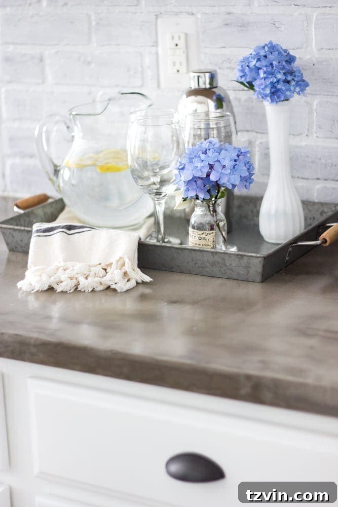 Elevate Your Kitchen: Pro Strategies for Cabinet Painting 18 Close-up of the kitchen counter area with painted cabinets, new cup pulls, and a glimpse of the DIY whitewashed brick backsplash, demonstrating the successful kitchen transformation.