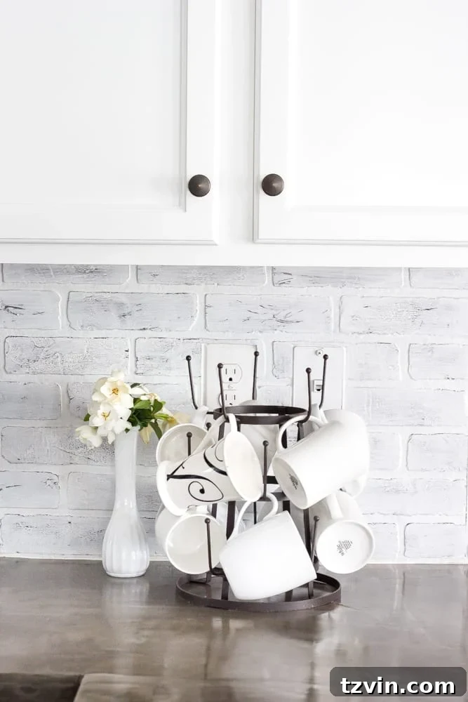 Elevate Your Kitchen: Pro Strategies for Cabinet Painting 19 Detailed shot of the budget-friendly DIY whitewashed brick backsplash in the newly painted kitchen, complementing the white cabinets and adding farmhouse charm.