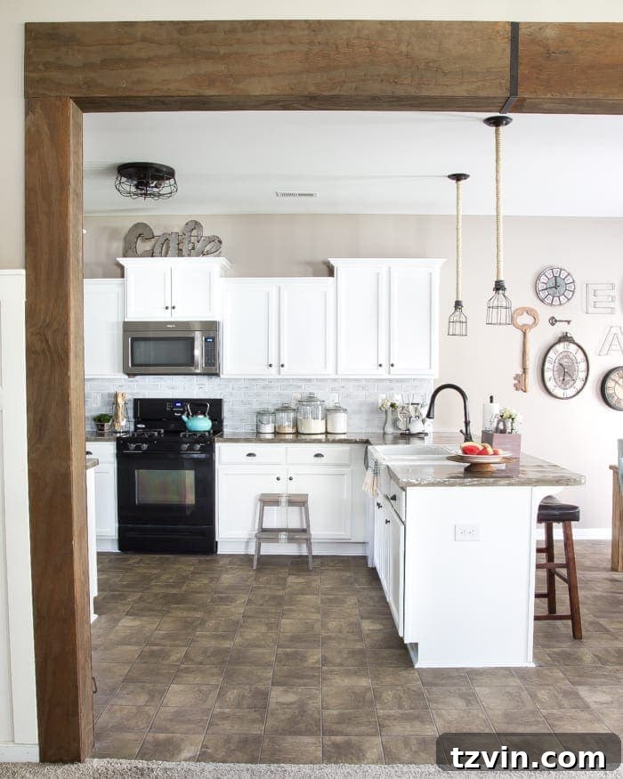 Elevate Your Kitchen: Pro Strategies for Cabinet Painting 22 The kitchen bar area with newly painted white cabinets and a glimpse of the DIY wood beam doorway, showing the overall flow and brightness of the renovated kitchen.