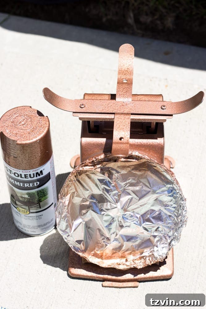 Rustic Chic Vintage Scale Makeover 5 Applying copper spray paint to the kitchen scale as the base for the faux rust finish. This step adds a metallic foundation.