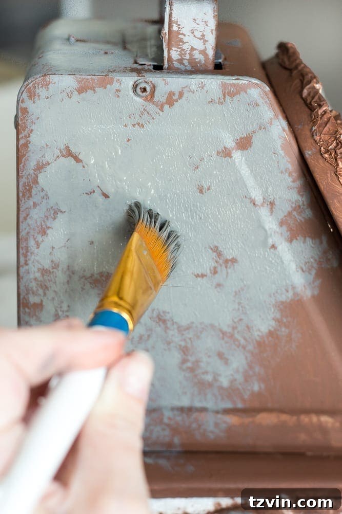 Rustic Chic Vintage Scale Makeover 8 Applying gray chalk paint with a pouncing technique to the faux rusted scale, allowing brown to show through for an authentic weathered look.