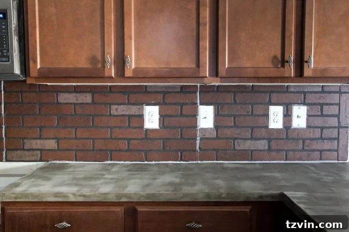 Caulking the seams of faux brick paneling to achieve a smooth and professional backsplash finish