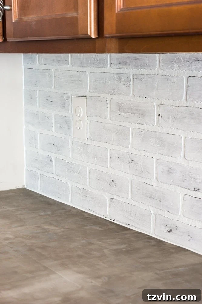 Sealing a newly installed whitewashed faux brick backsplash with Fusion Mineral Paint Tough Coat for durability