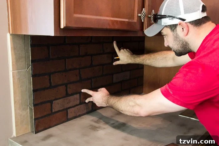 Dry fitting HDF faux brick paneling to ensure a perfect fit for the kitchen backsplash