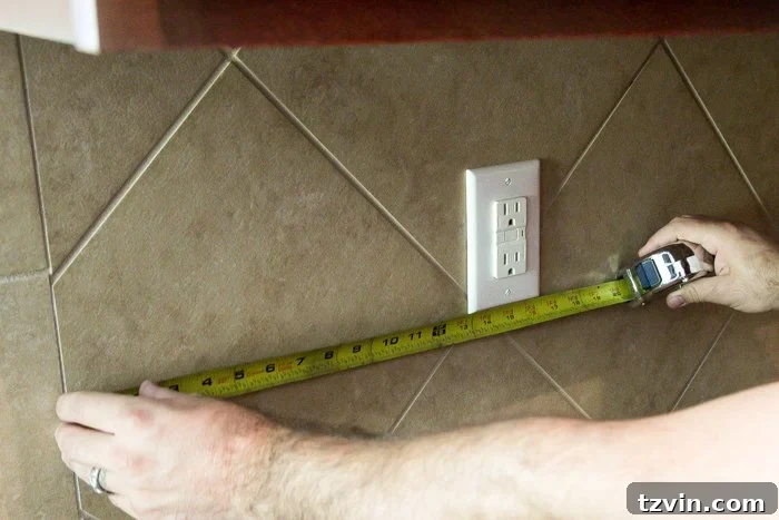 Measuring a kitchen backsplash to accurately mark outlet locations on faux brick paneling