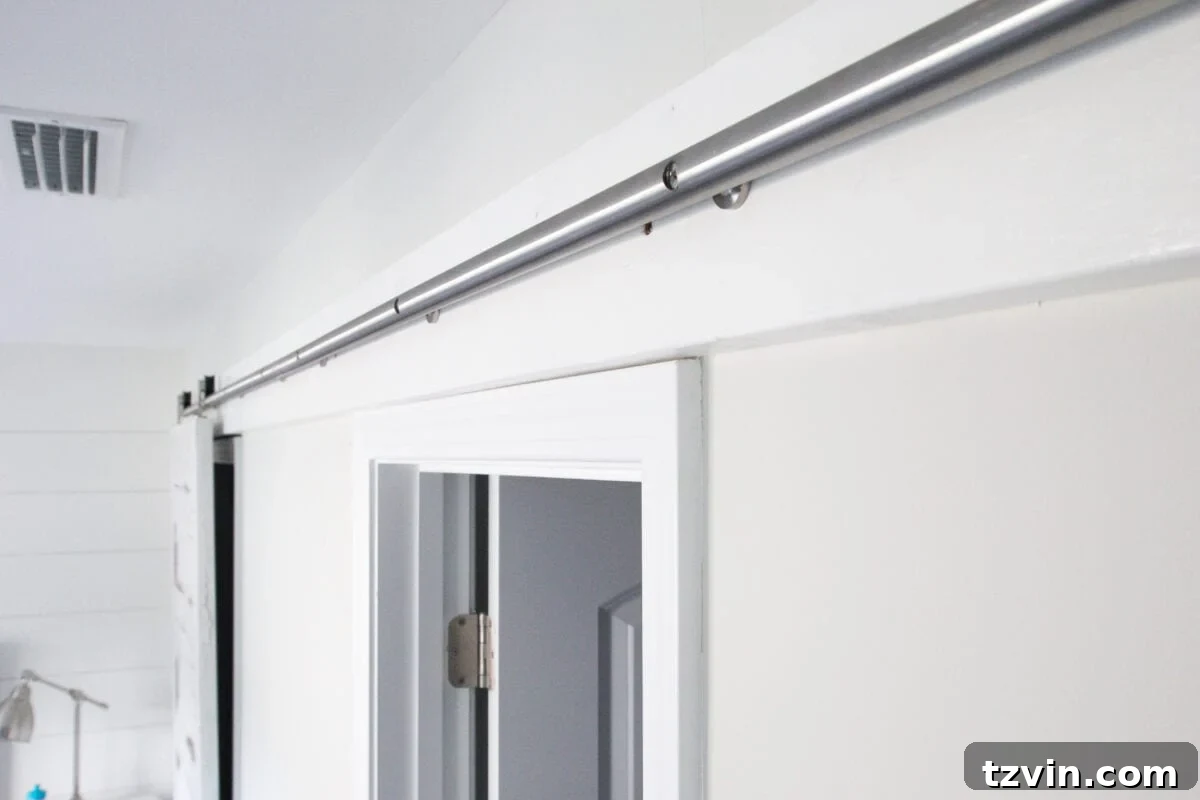 DIY Sliding Barn Door Installation 10 The fully installed barn door track system, ready for the doors to be hung.