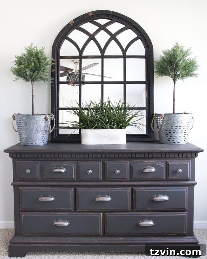 Get the Look: Our Rustic Modern Master Bedroom Transformation 14 After: Transformed Craigslist dresser with new hardware, mirror, and topiaries in the rustic modern bedroom.