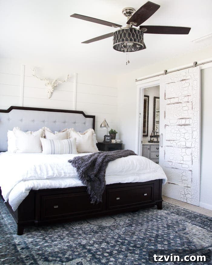 Get the Look: Our Rustic Modern Master Bedroom Transformation 4 Rustic modern master bedroom featuring a stylish ceiling fan, painted upholstered bed, and unique nightstands.