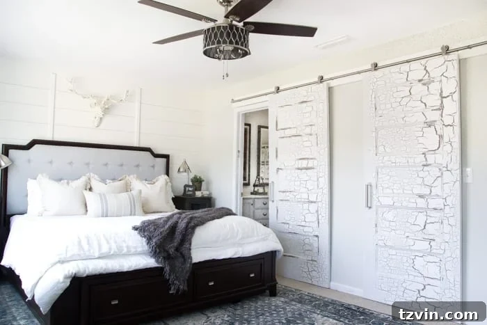 Get the Look: Our Rustic Modern Master Bedroom Transformation 7 After: Sliding barn doors enhance the rustic modern aesthetic and improve functionality in the master bedroom.