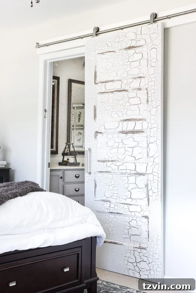 Get the Look: Our Rustic Modern Master Bedroom Transformation 8 Close-up of beautifully distressed sliding barn doors, adding texture and rustic charm to the bedroom.