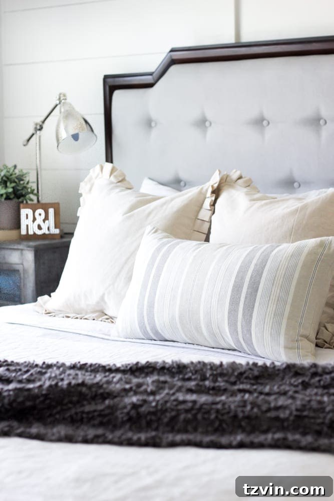 Get the Look: Our Rustic Modern Master Bedroom Transformation 9 Bright white bedding creates contrast against dark furniture in a rustic modern master bedroom.