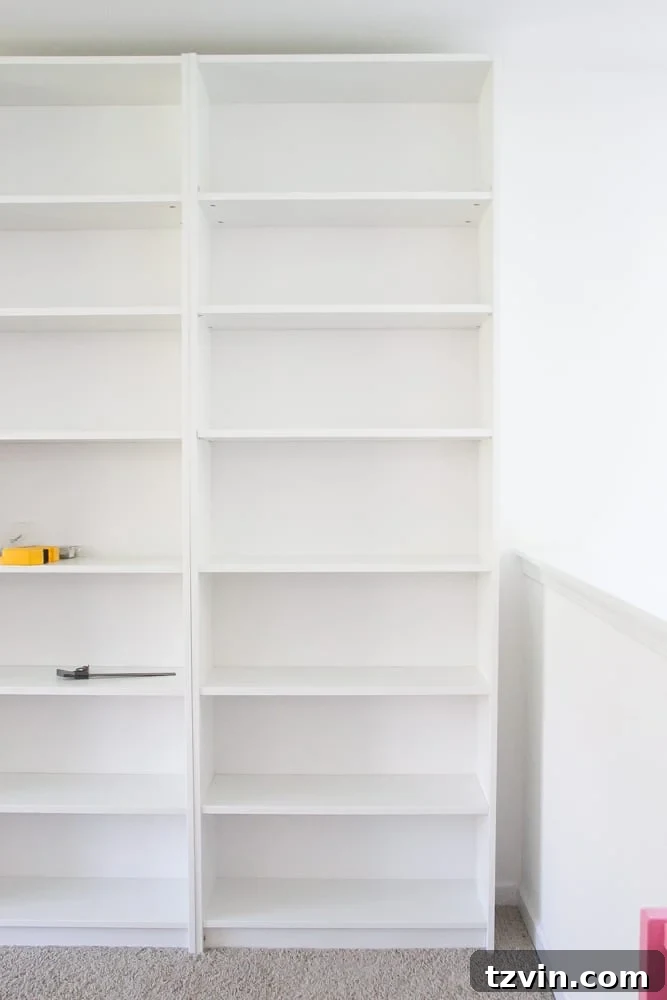 Freshly assembled IKEA Billy bookcases positioned against a wall, ready for conversion into built-ins.