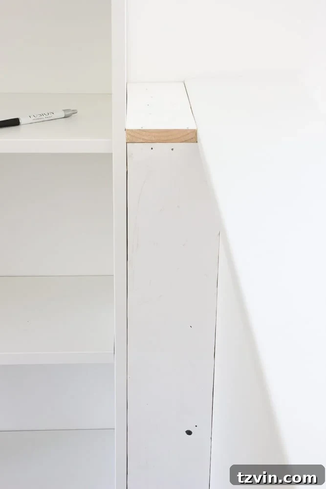 Filling a gap with a constructed box between an IKEA bookcase and a wall, making the built-in shelf flush.