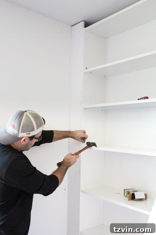 Securing an IKEA bookcase to the wall by adding a face board, creating a sturdy built-in shelf.
