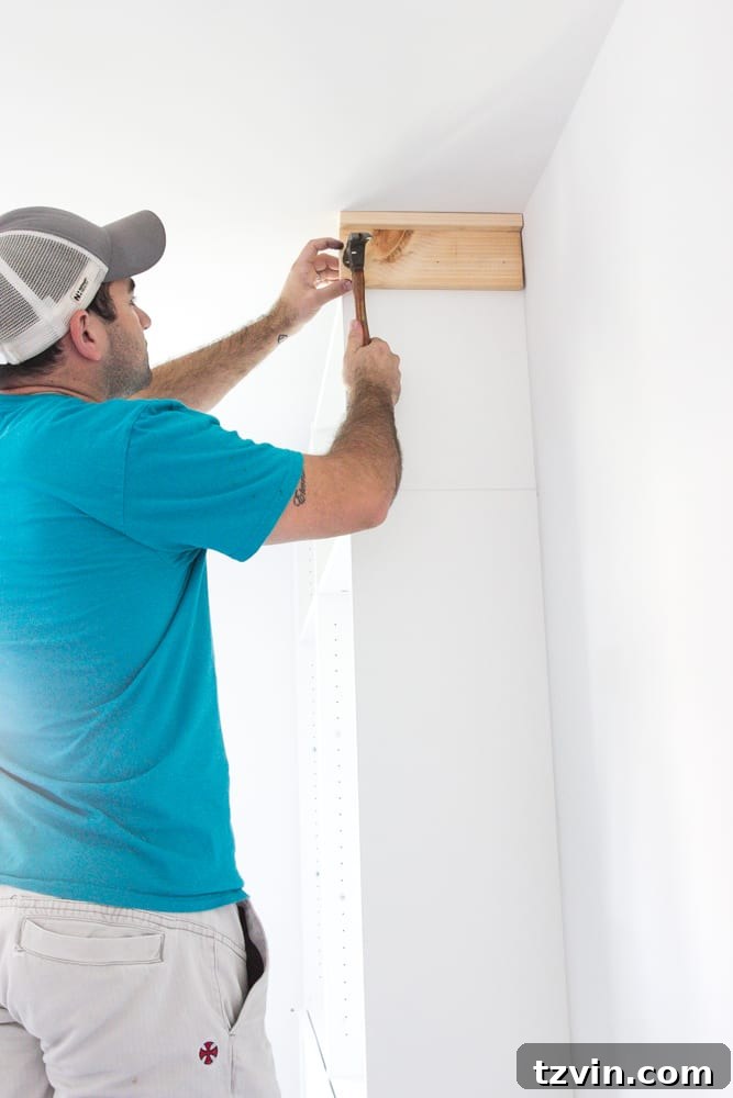 Adding a custom header to the top of IKEA bookcases to fill the gap at the ceiling, enhancing the built-in appearance.