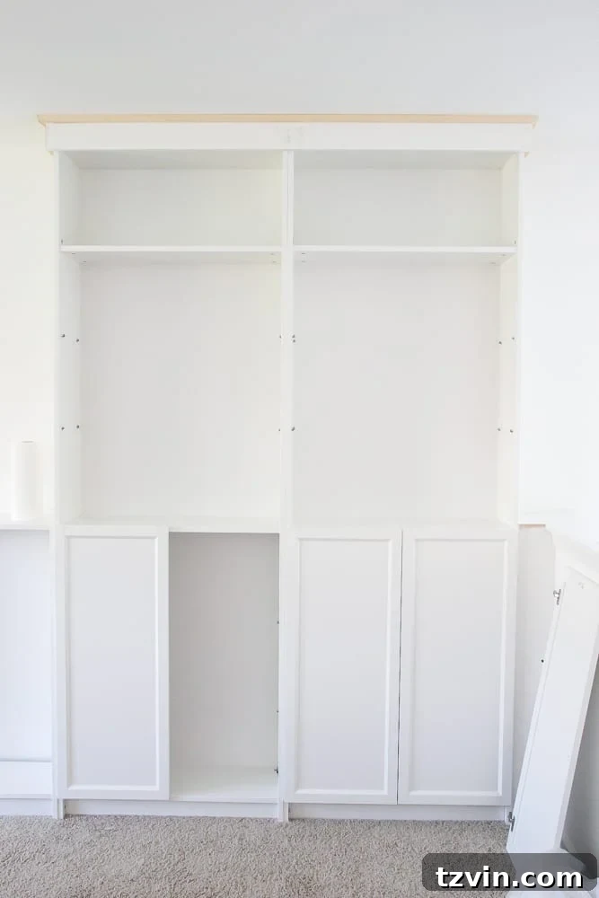Installing Oxberg doors onto IKEA Billy bookcases to create functional base cabinets within the built-in unit.