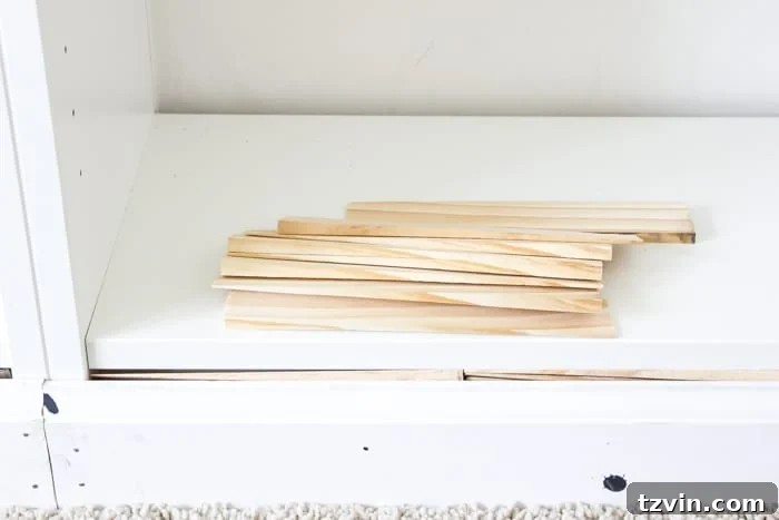Using wood shims to fill gaps between IKEA bookcase built-ins and the baseboard, ensuring a seamless fit.